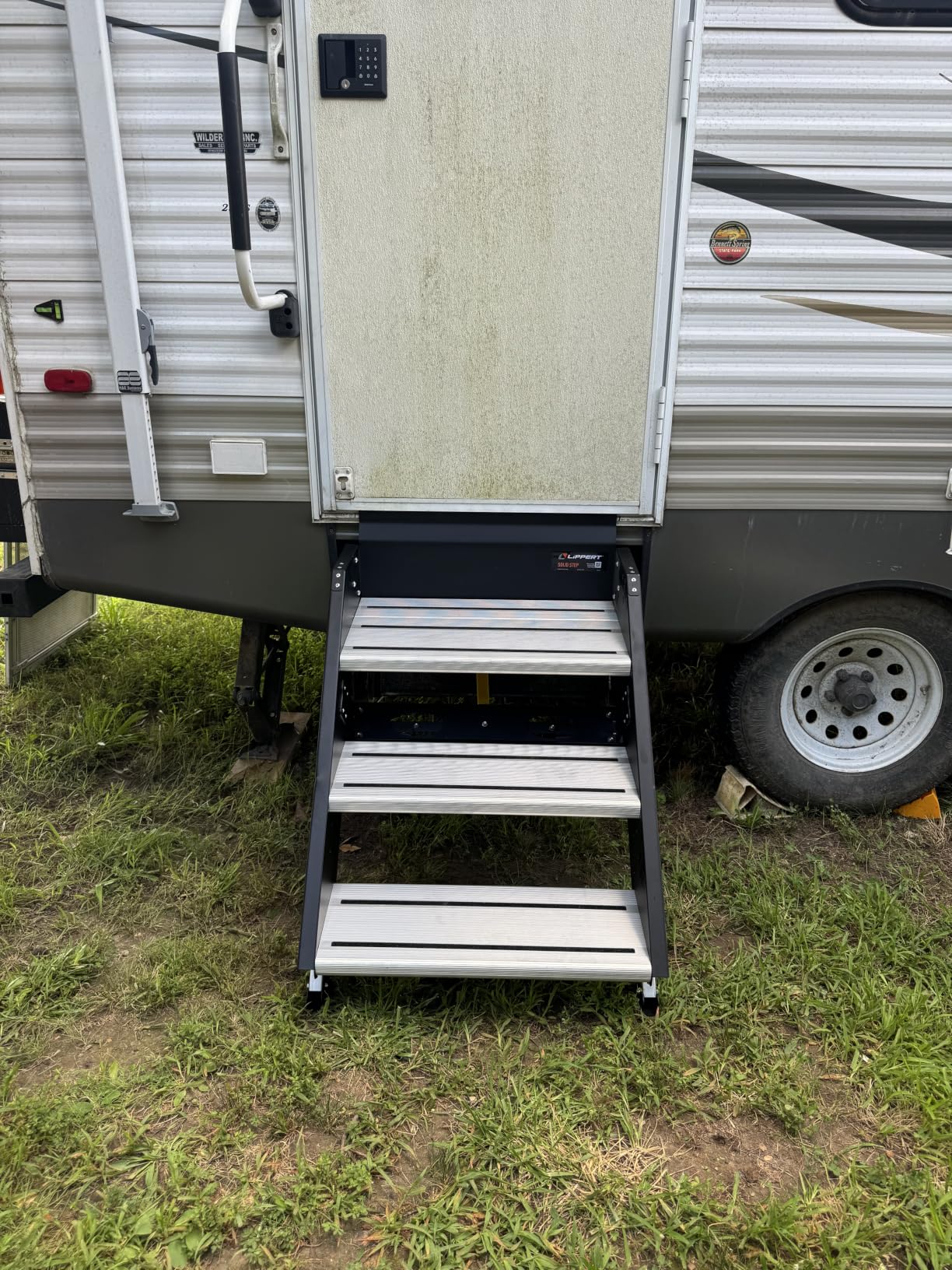 Lippert Components - 791572 Solid Step Triple Step for RV and Travel Trailer Entry Doorway Black 26-inch | Extra-wide top tread with aluminum treads, adjustable legs for uneven ground, folds into doorway, hardware included customer photo 1